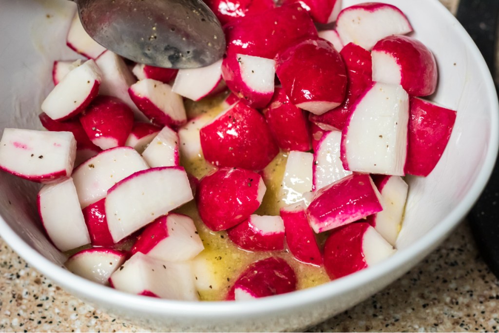 mixing radishes in with melted butter