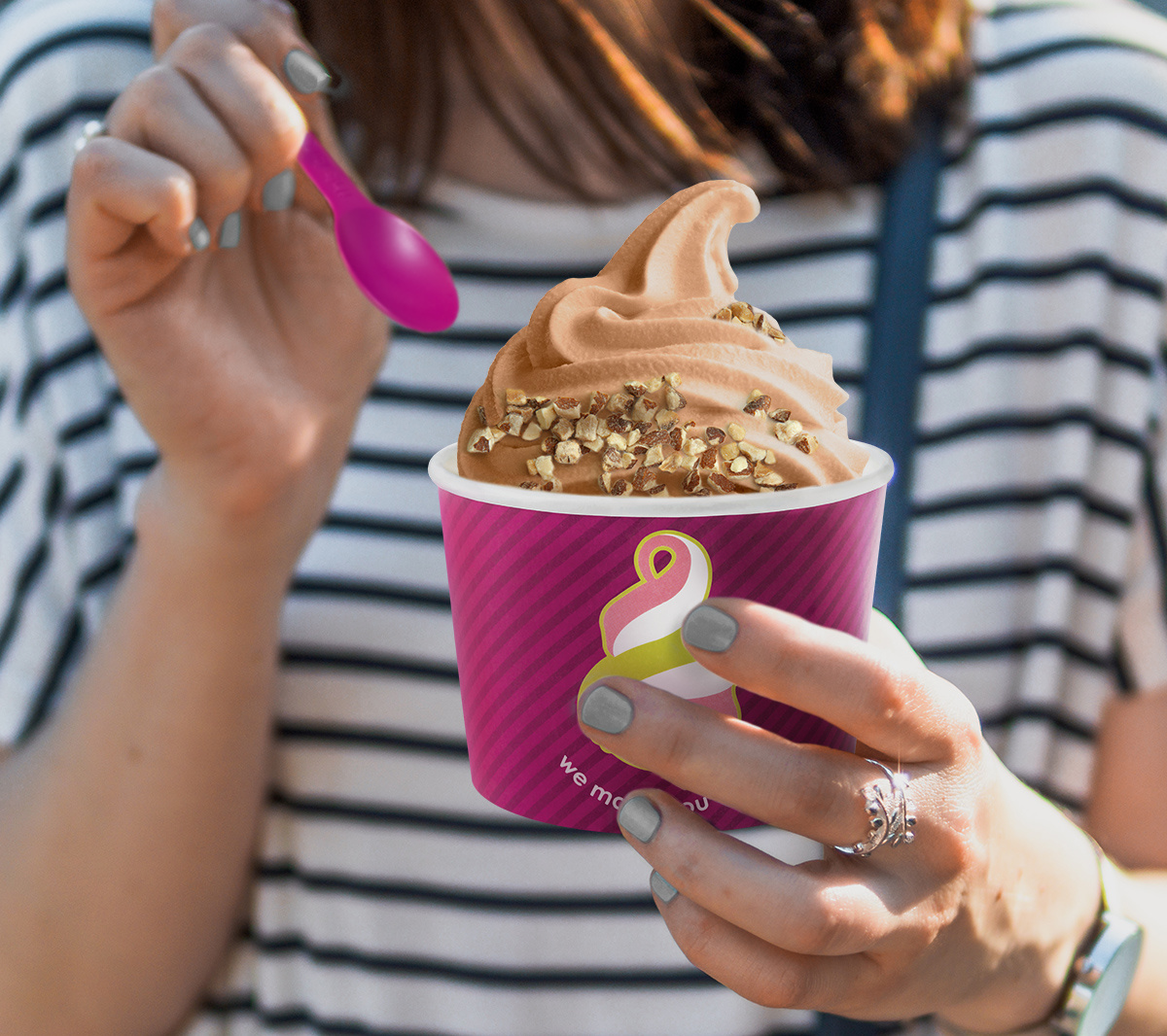 woman holding a Menchie's low carb frozen yogurt, one of the birthday freebies available to mySmileage Rewards members