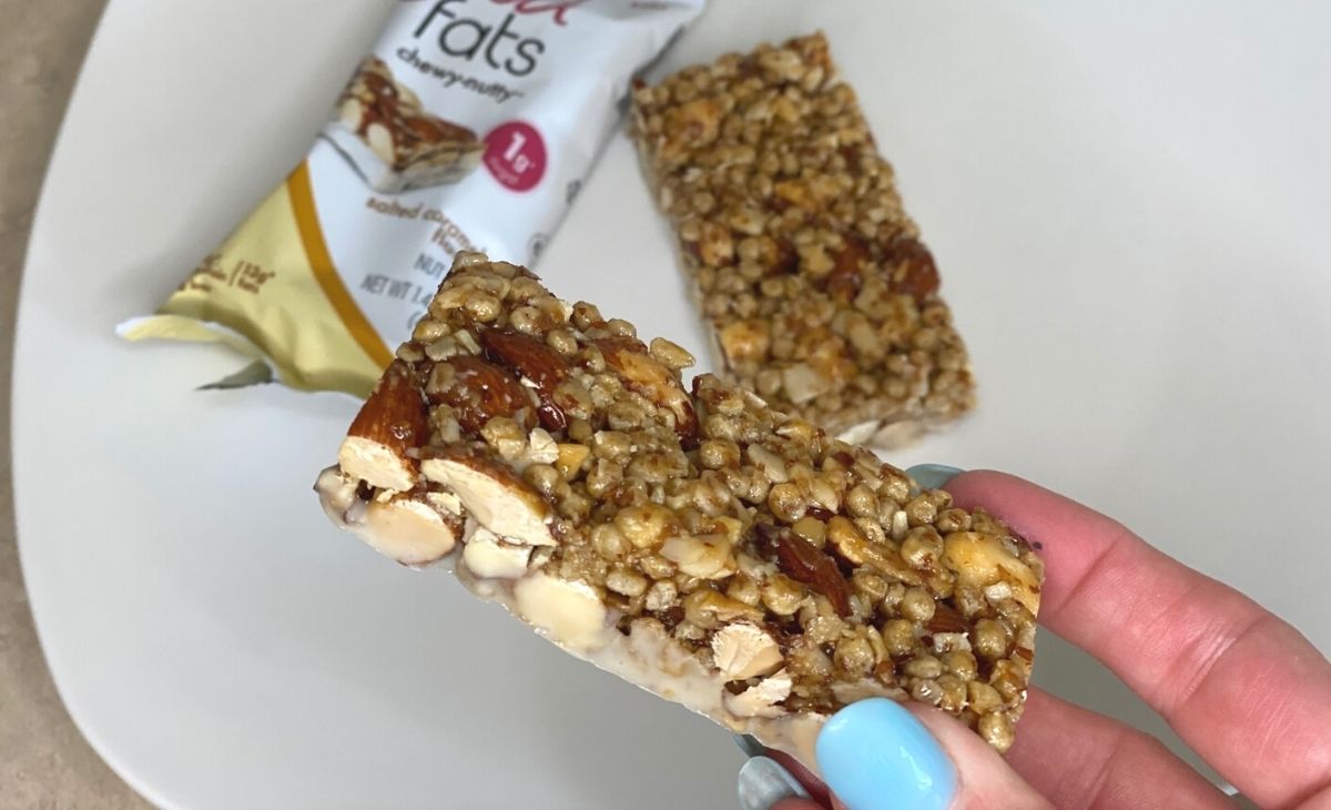 A hand holding a nut bar snack
