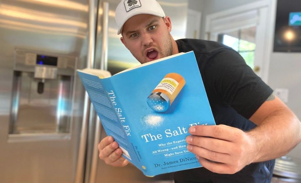 A man reading The Salt Fix with a surprised expression