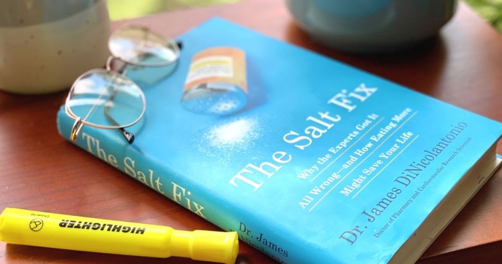 A book next to a highlighter on a table