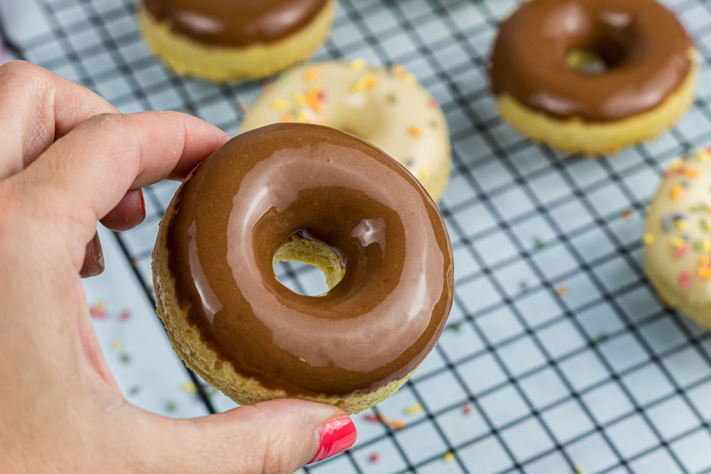 holding chocolate frosted keto donut 