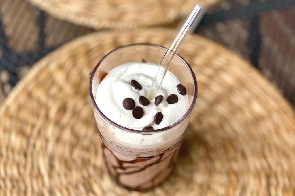 A chocolate frappuccino on a place mat
