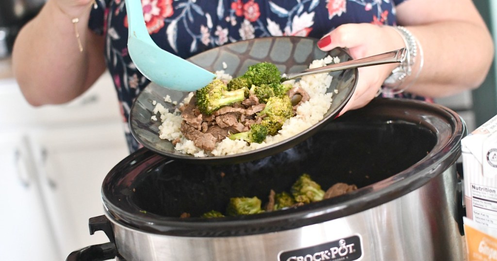 dishing up beef and broccoli from slow cooker