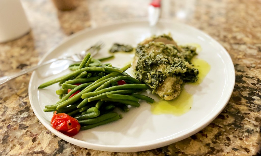 white plate with chicken and green beans 