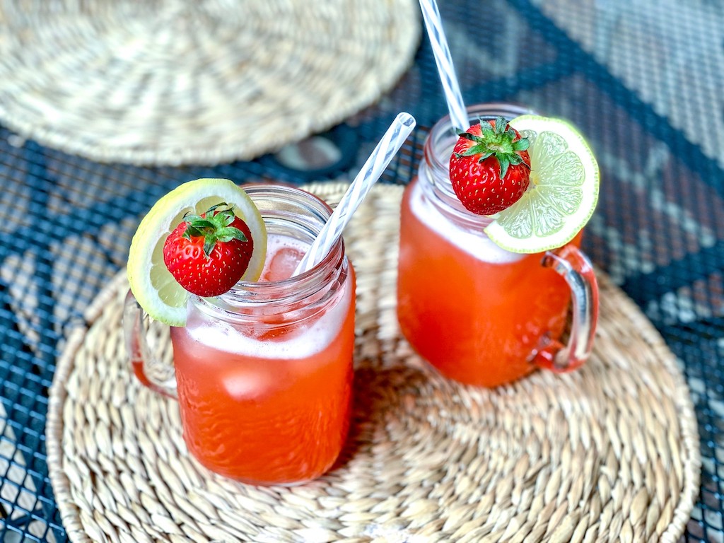 keto strawberry lemonade drinks with fresh strawberries and lemon wedge 