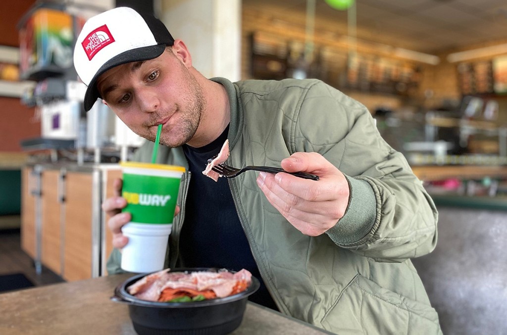 man eating subway protein bowl