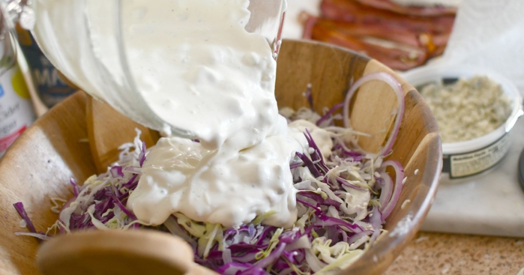 pouring dressing on bacon blue cheese dressing