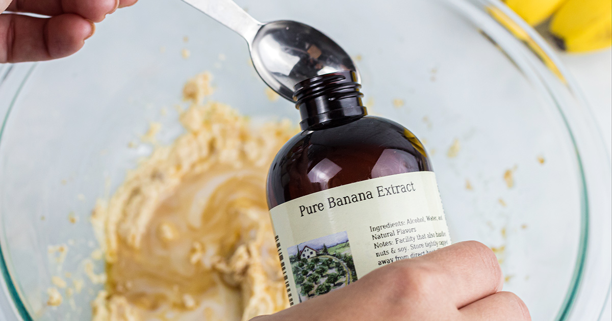 pouring pure banana extract into measuring spoon