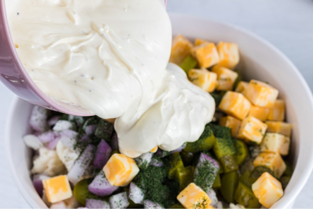 pouring dressing over salad