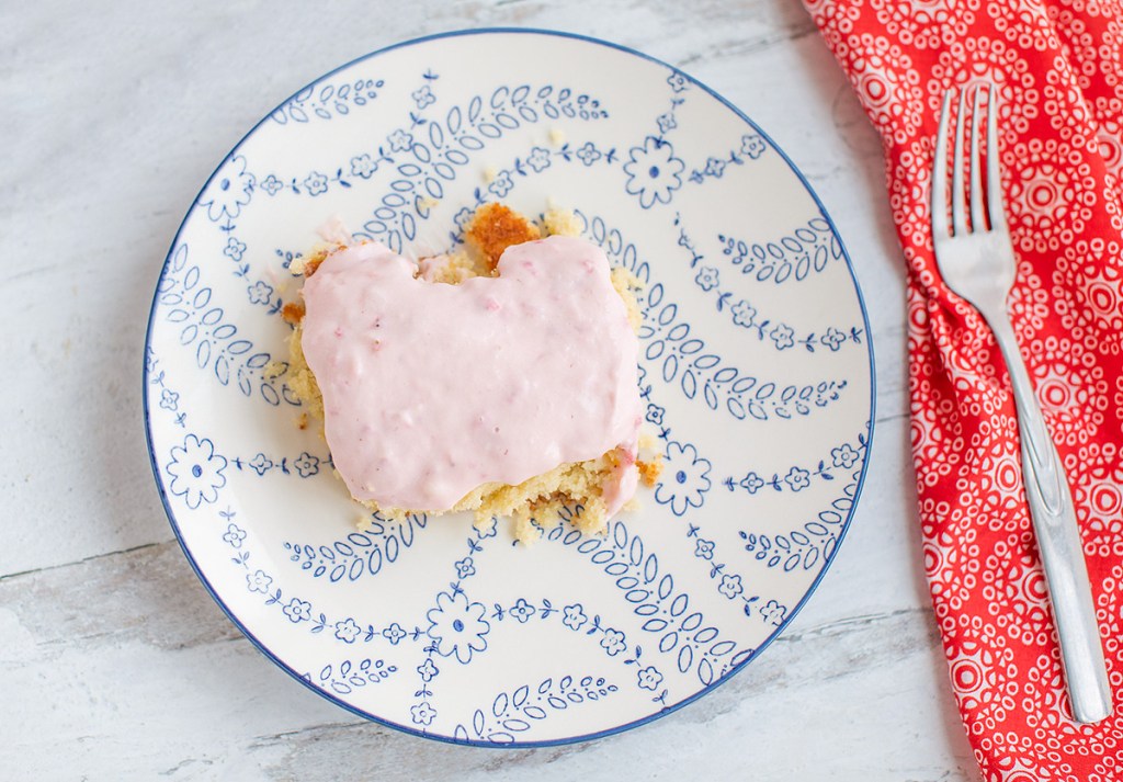 keto almond cake with berry frosting on plate