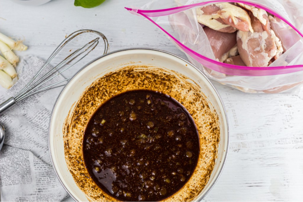 marinade in bowl and chicken thighs in a bag