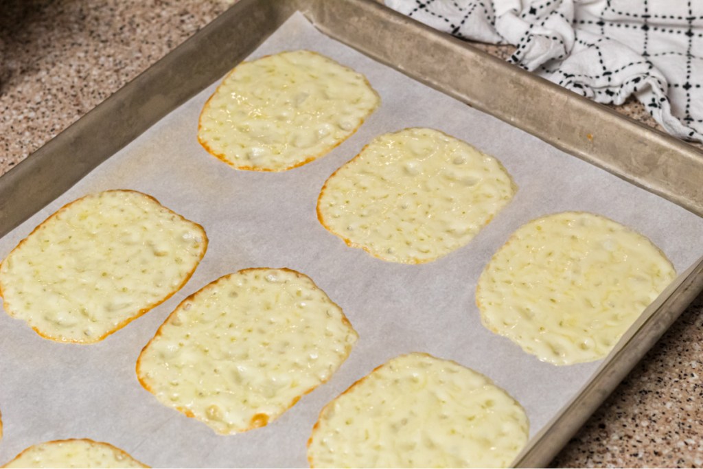 melted provolone cheese on baking sheet