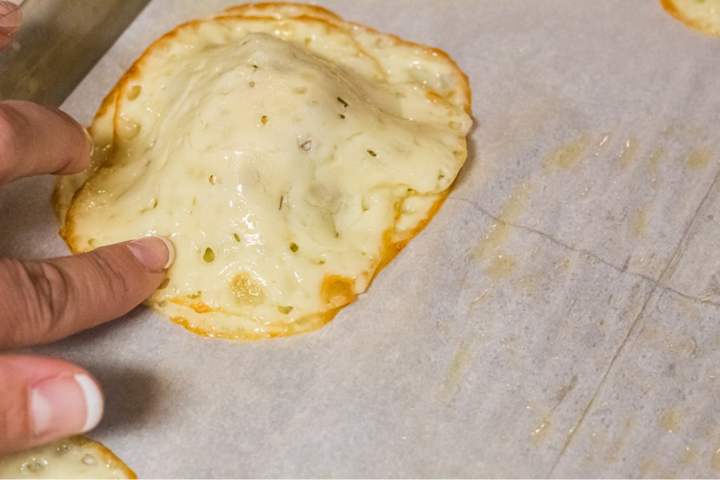 pressing down on cheese to make sure the sides are sealed on ravioli