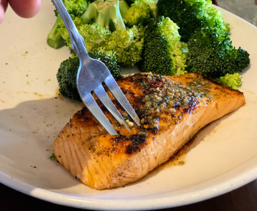 sticking a fork in a piece of salmon