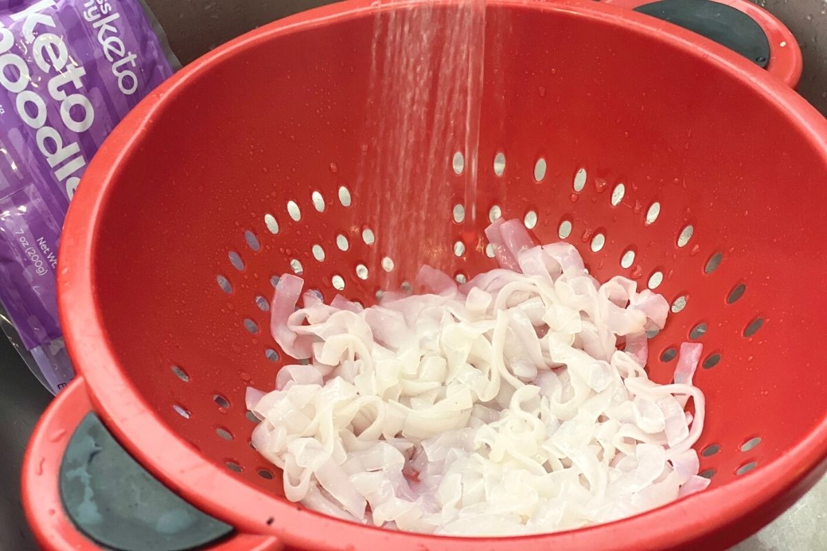 Straining some noodles in a sink