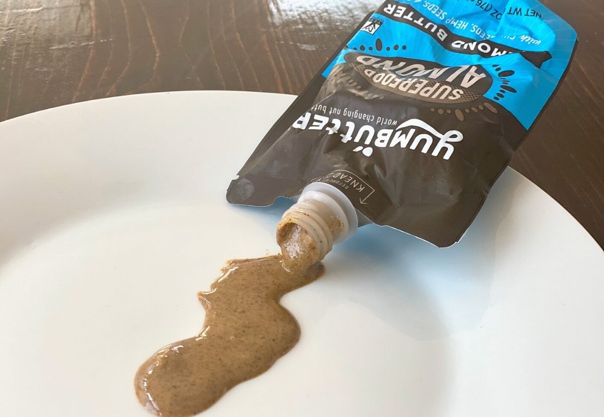 Almond butter spilling out of a yumbutter pouch