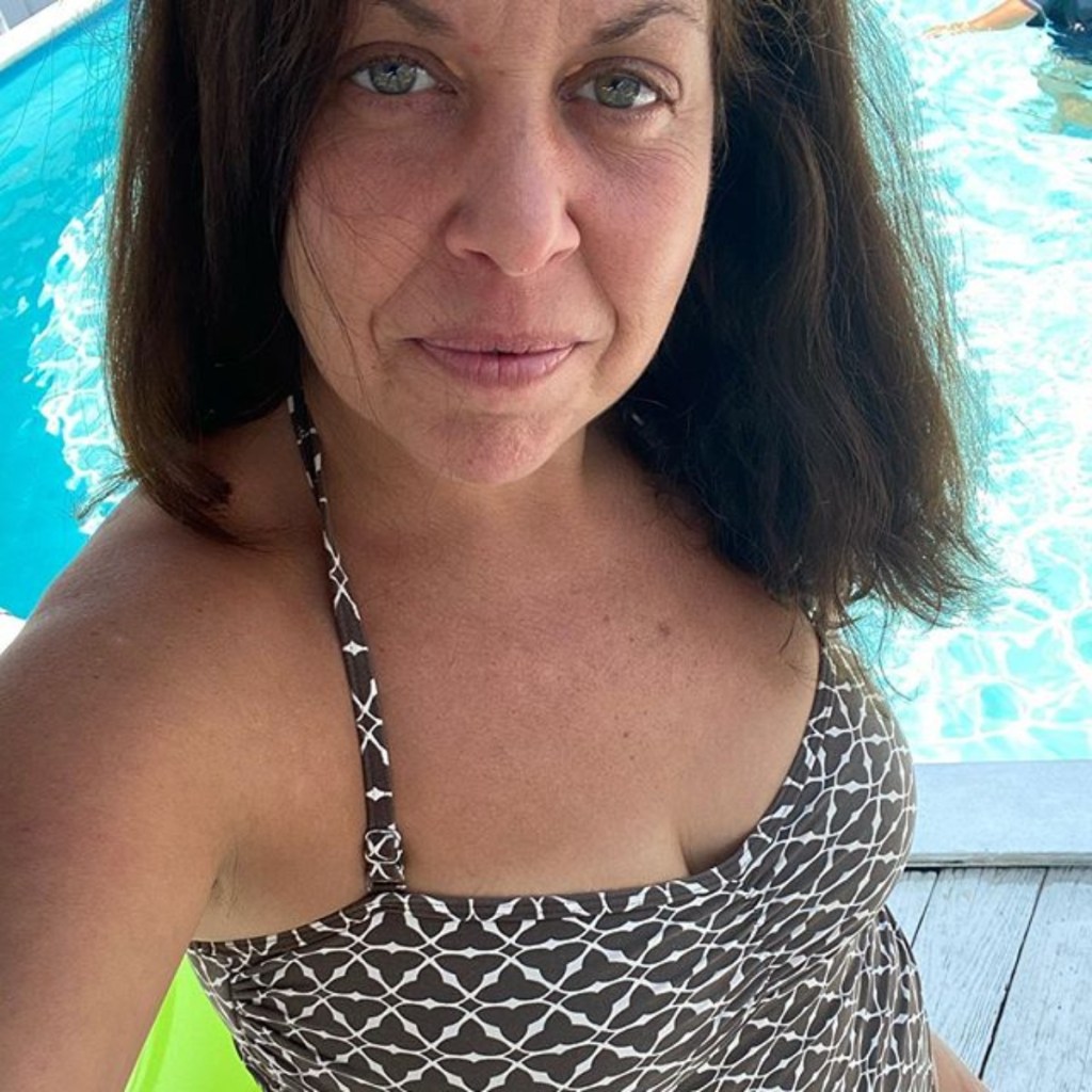 woman taking selfie by pool