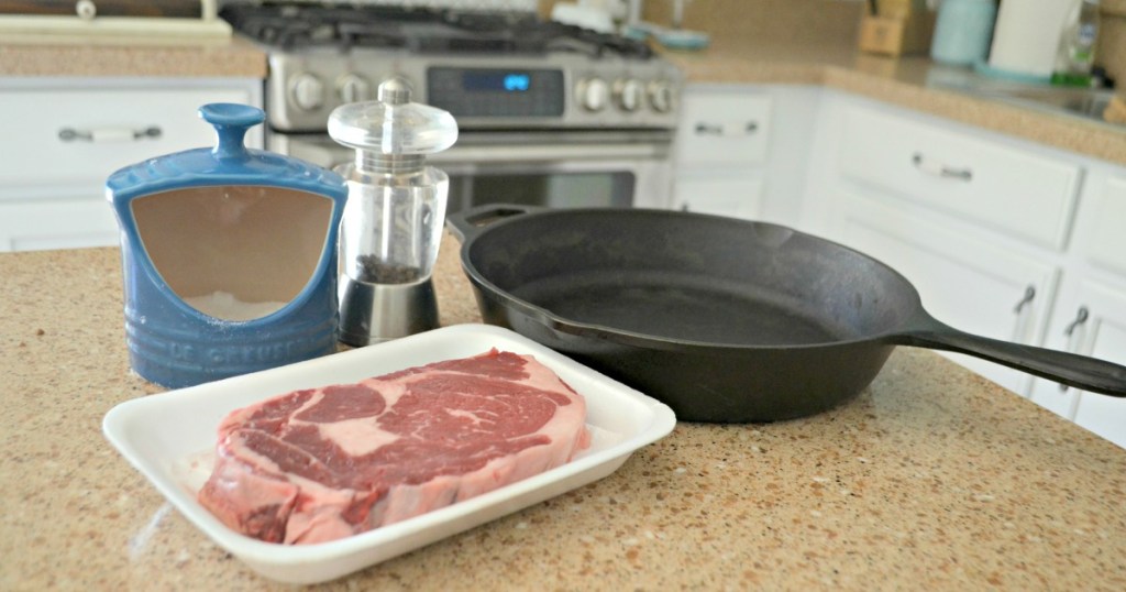 cast iron skillet and steak on the counter