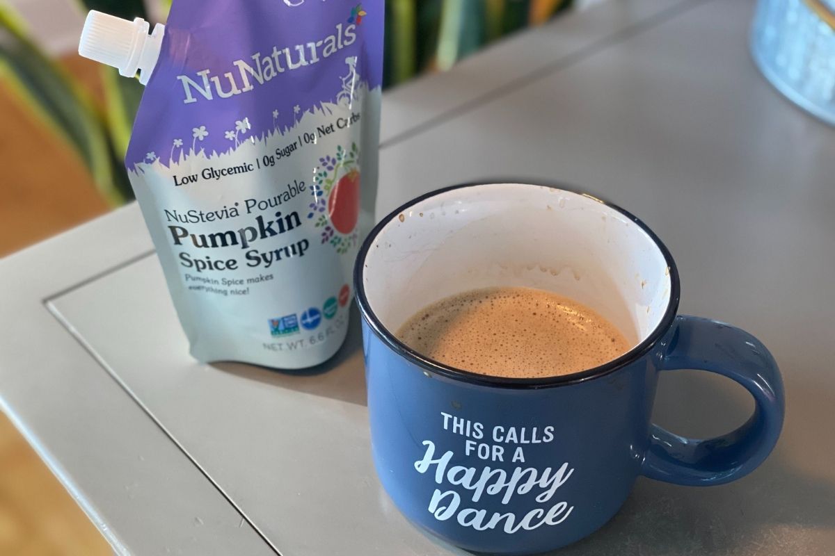 latte in a mug next to some NuNaturals syrup