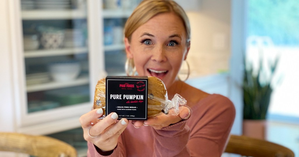 woman holding up pumpkin bread package