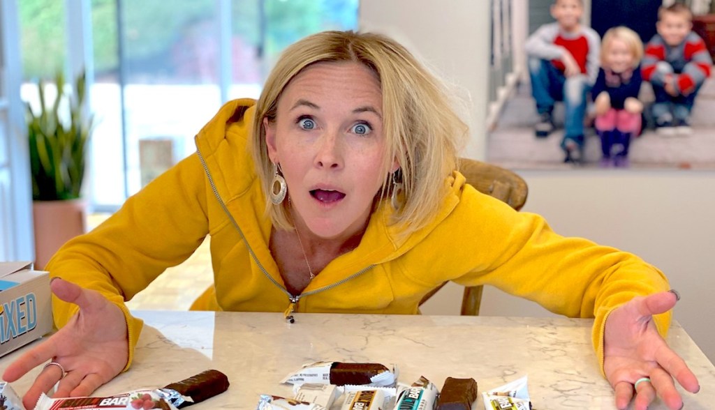 woman wearing yellow sweatshirt with hands on counter