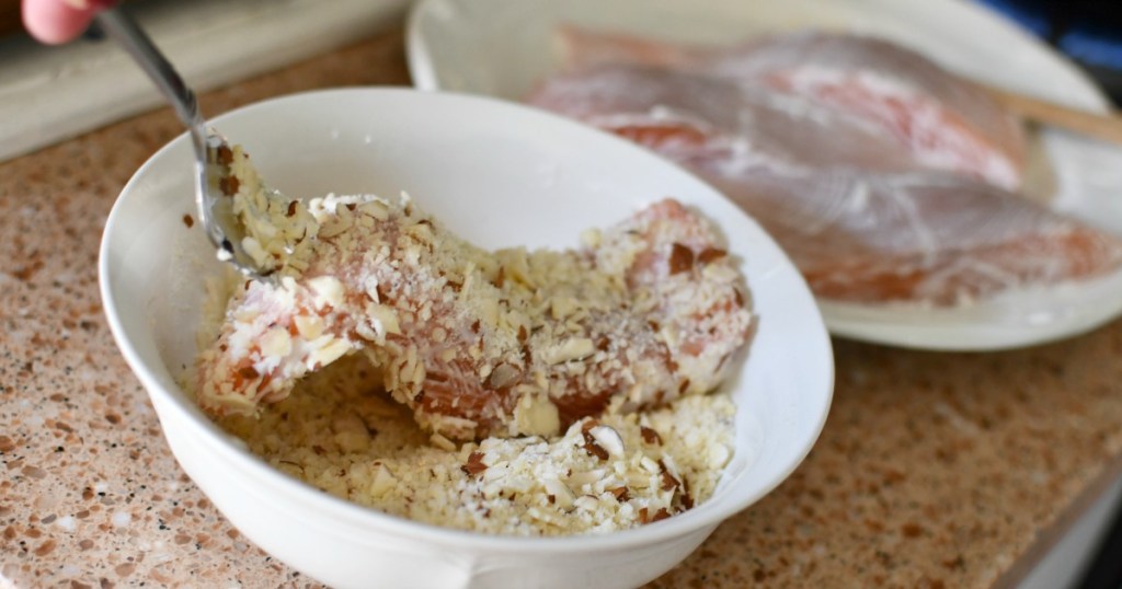 dredging salmon in almonds and parm cheese