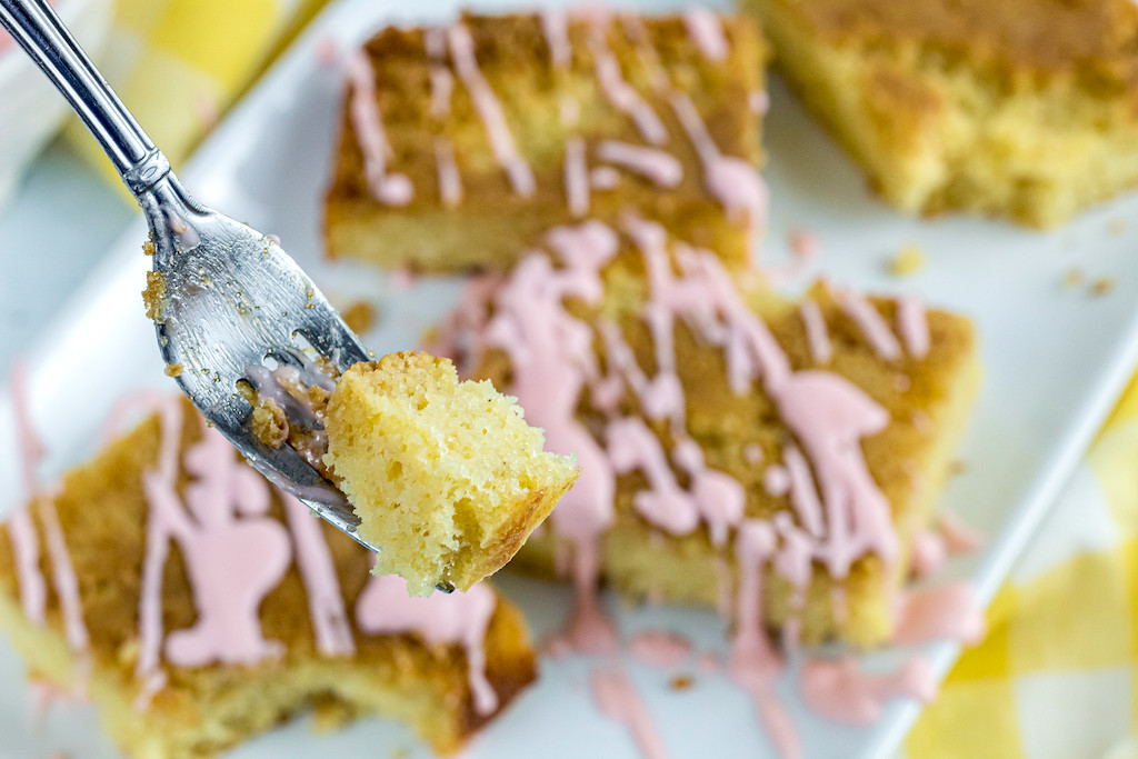 fork taking bit of keto pineapple cake with cherry glaze