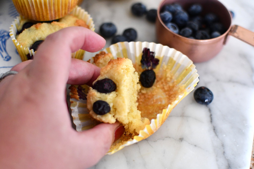 taking blueberry muffin out of cupcake liner 