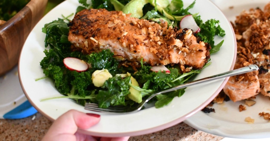 holding plate of keto salmon salad 