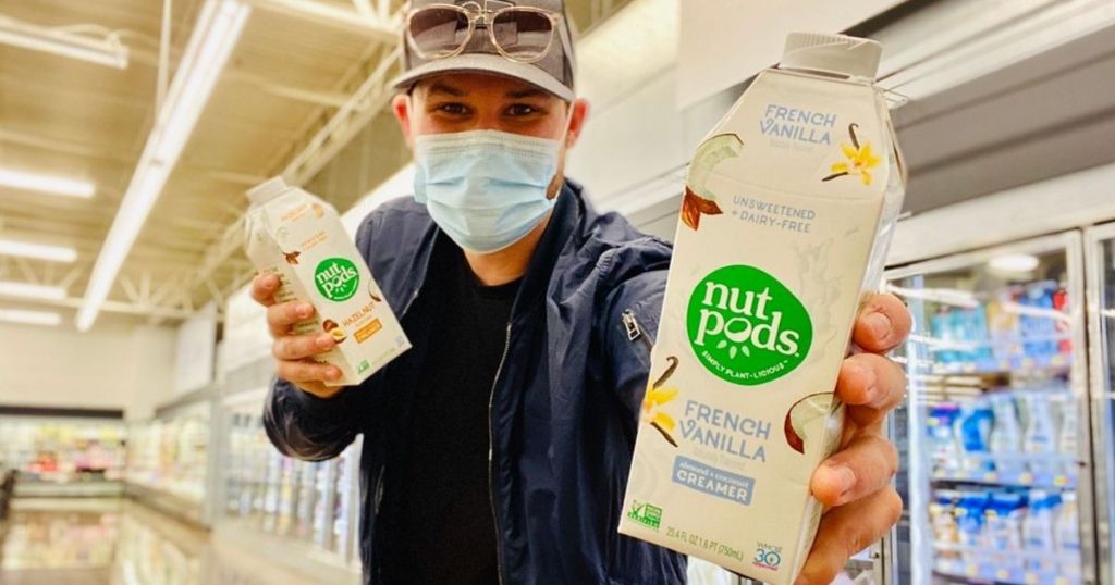 man wearing face mask holding Nut Pods in store