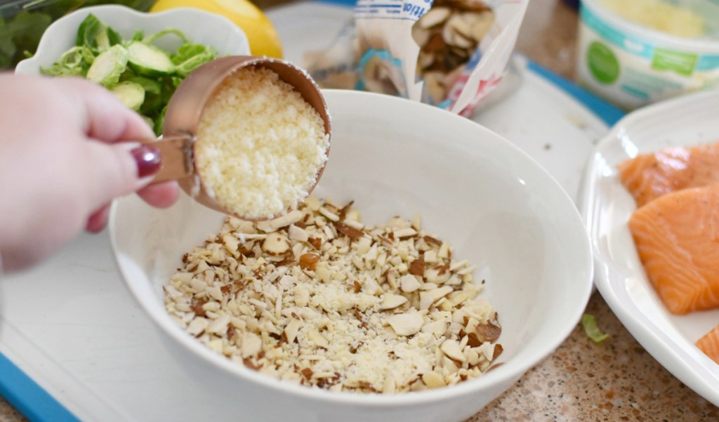 adding parmesan cheese to almond crust mix