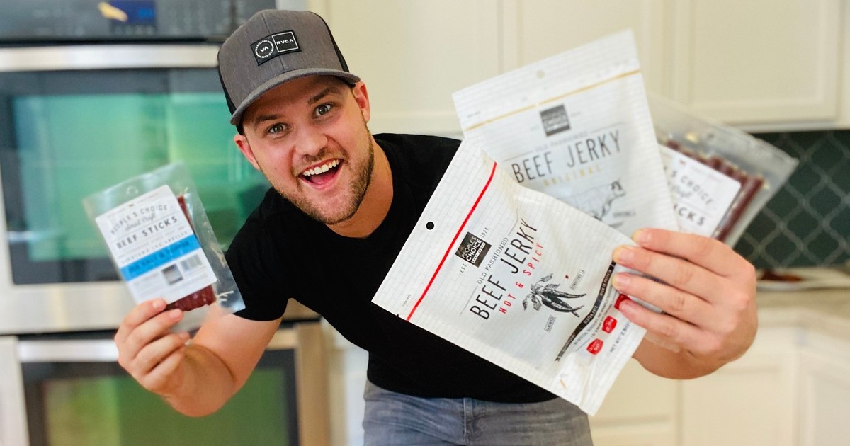man holding packages of beef jerky