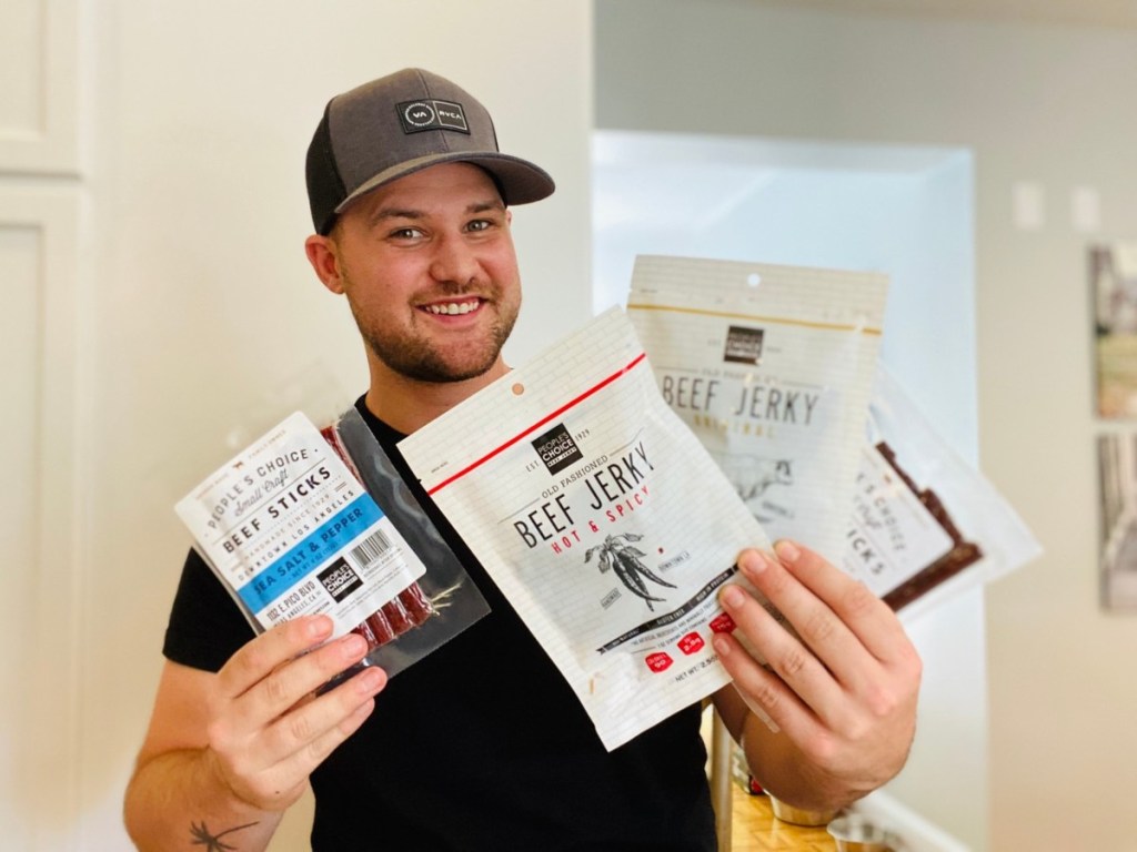 man holding packages of beef jerky