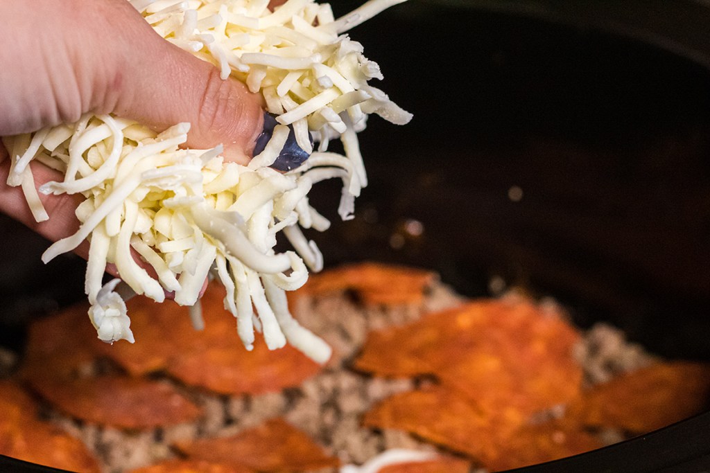 adding shredded mozzarella to crockpot