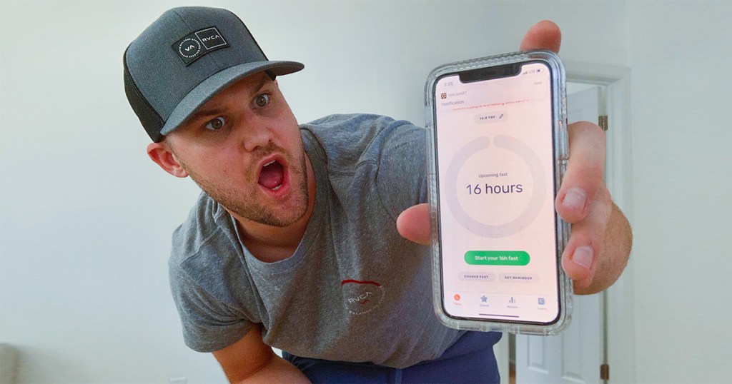 man holding phone with intermittent fasting app