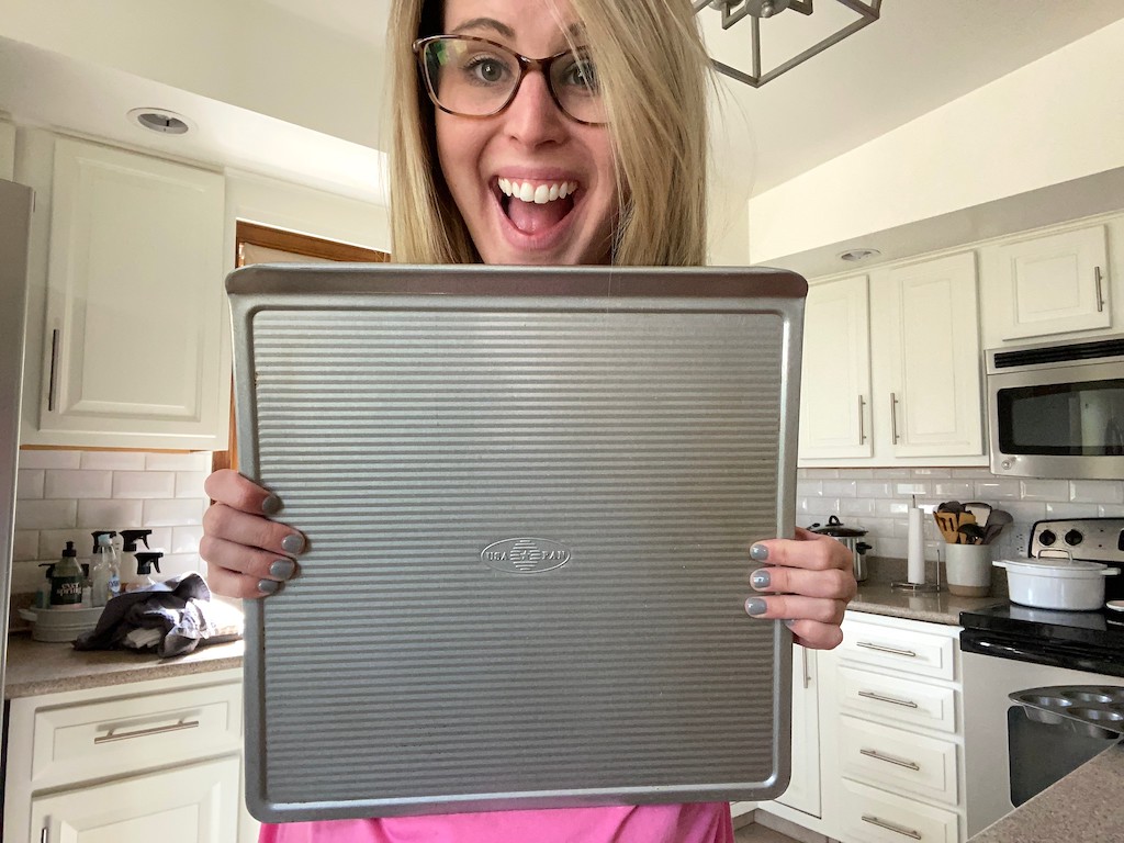 woman holding USA pan in kitchen