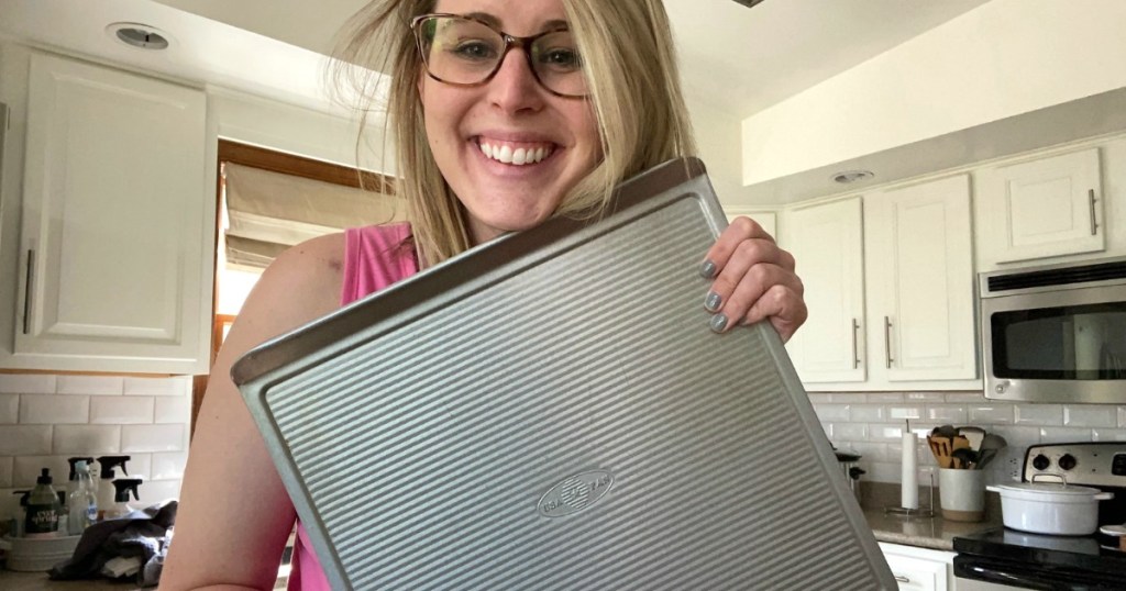 woman holding USA pan in kitchen 