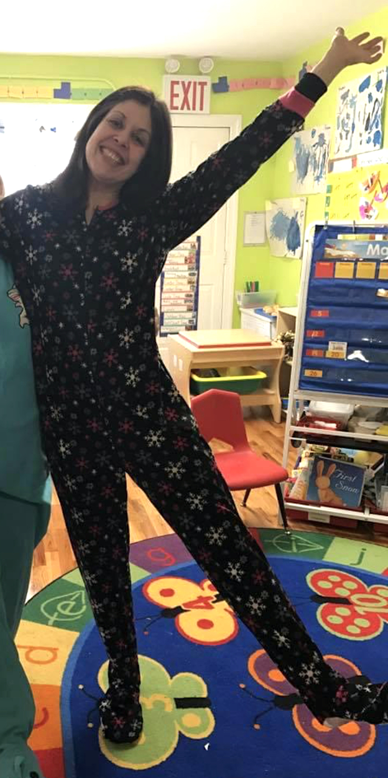 woman smiling while wearing Christmas onesie 