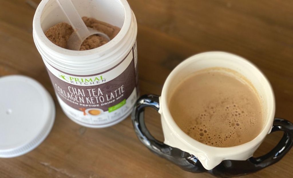 Chai latte mix next to a mug of chai on a table