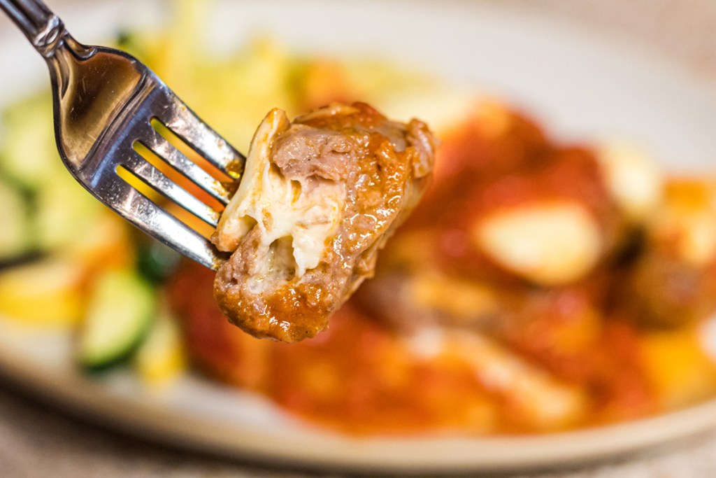 cheese stuffed italian sausage on a fork
