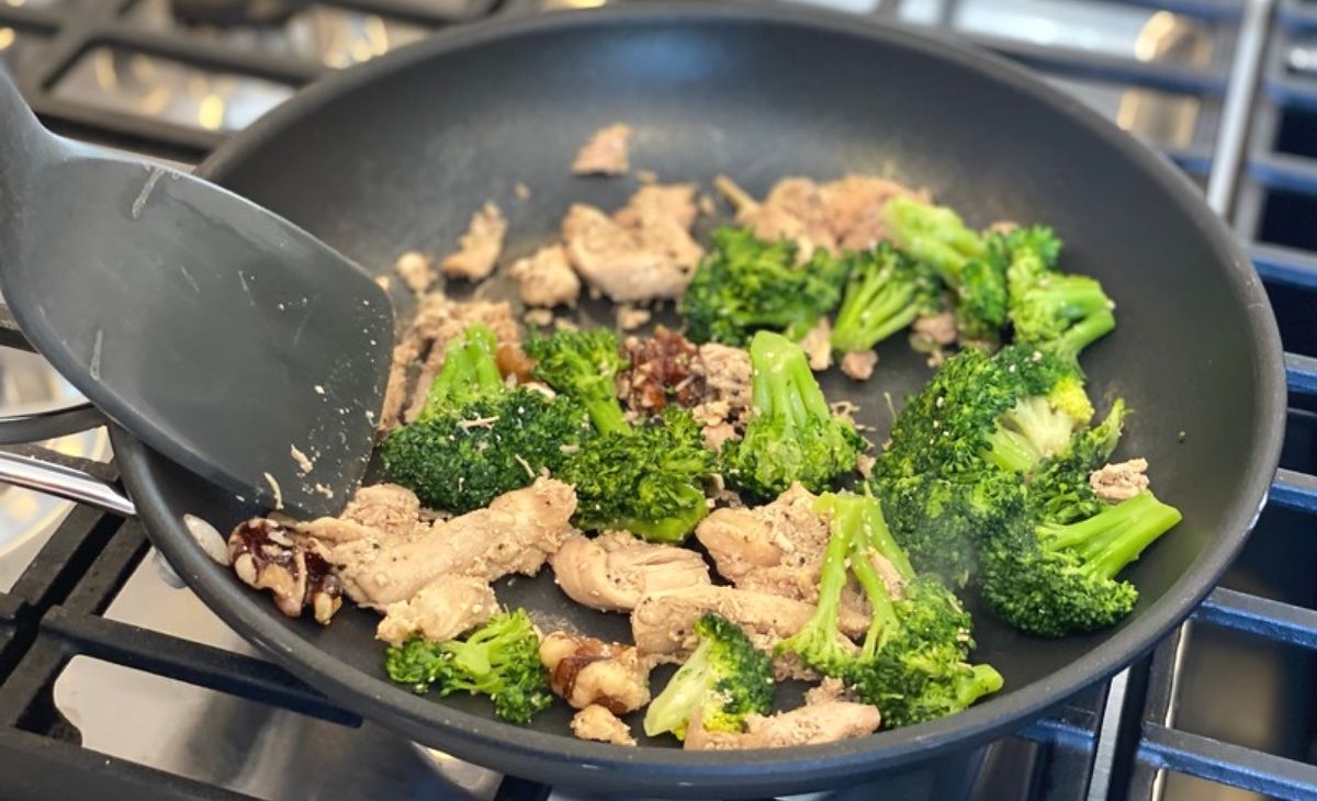 Broccoli and chicken in a skillet on the stove