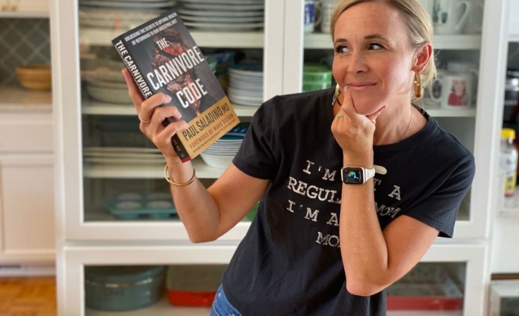 A woman holding a book and looking at it