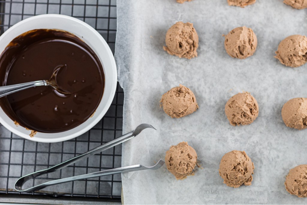 fat bombs on tray and melted chocolate in bowl