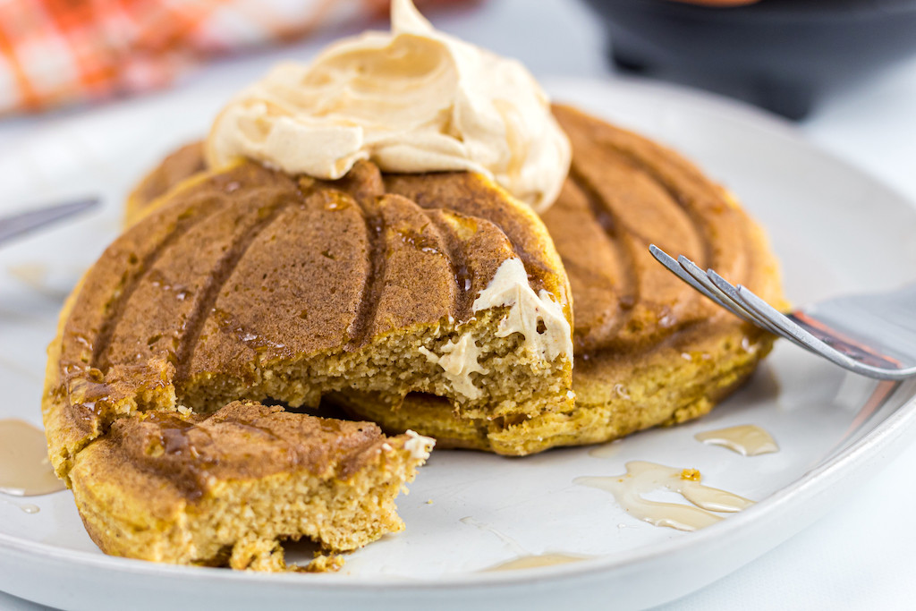 digging into keto pumpkin chaffle with whipped cream 
