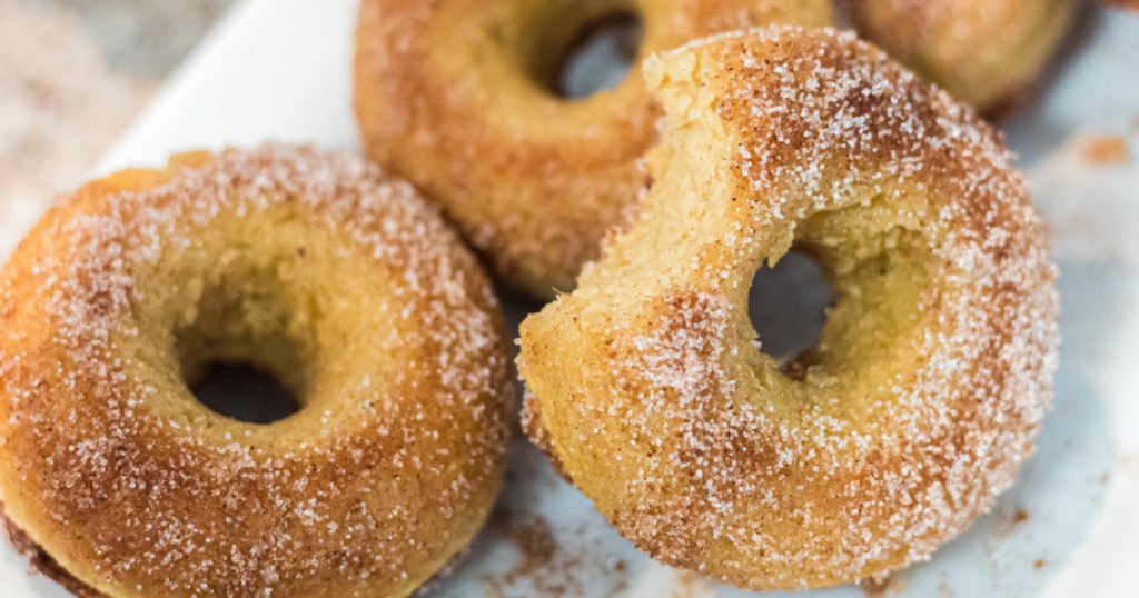 Keto pumpkin donuts with one that has a bite out of it