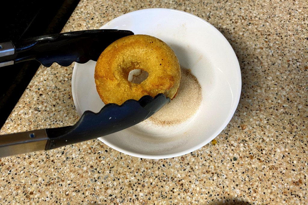 dipping donuts in cinnamon and granular