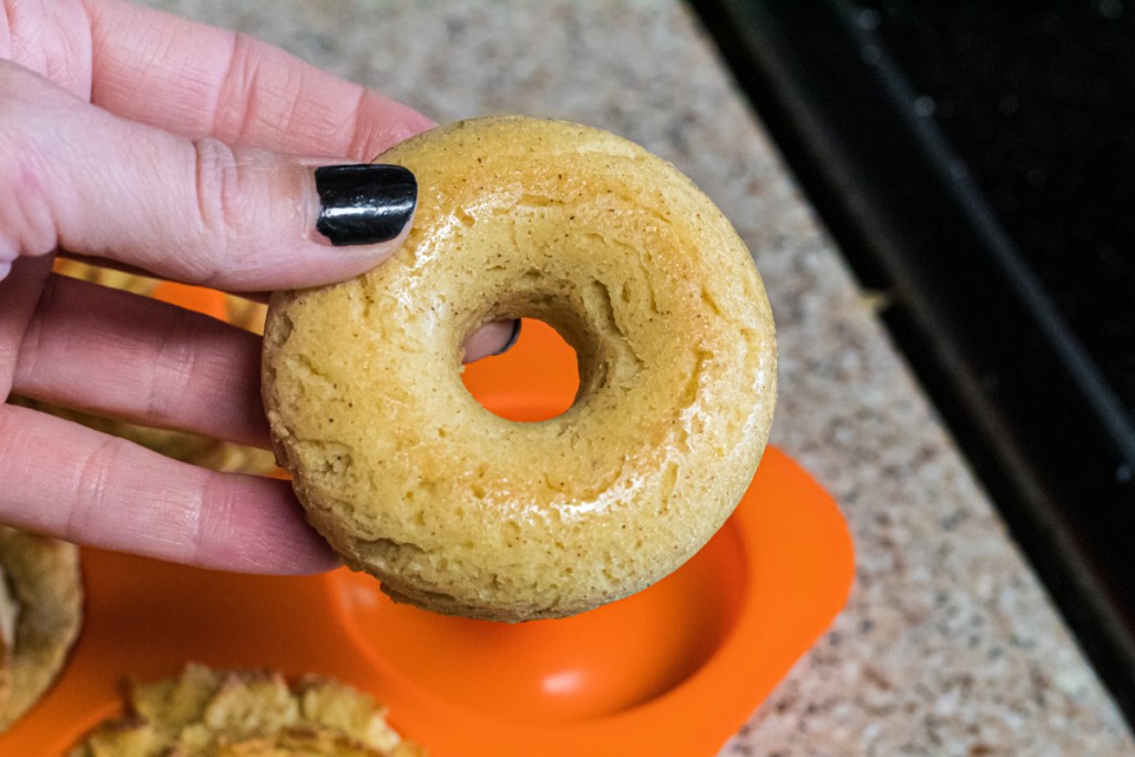 holding a baked donut