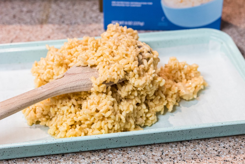 spreading keto rice krispie on a pan