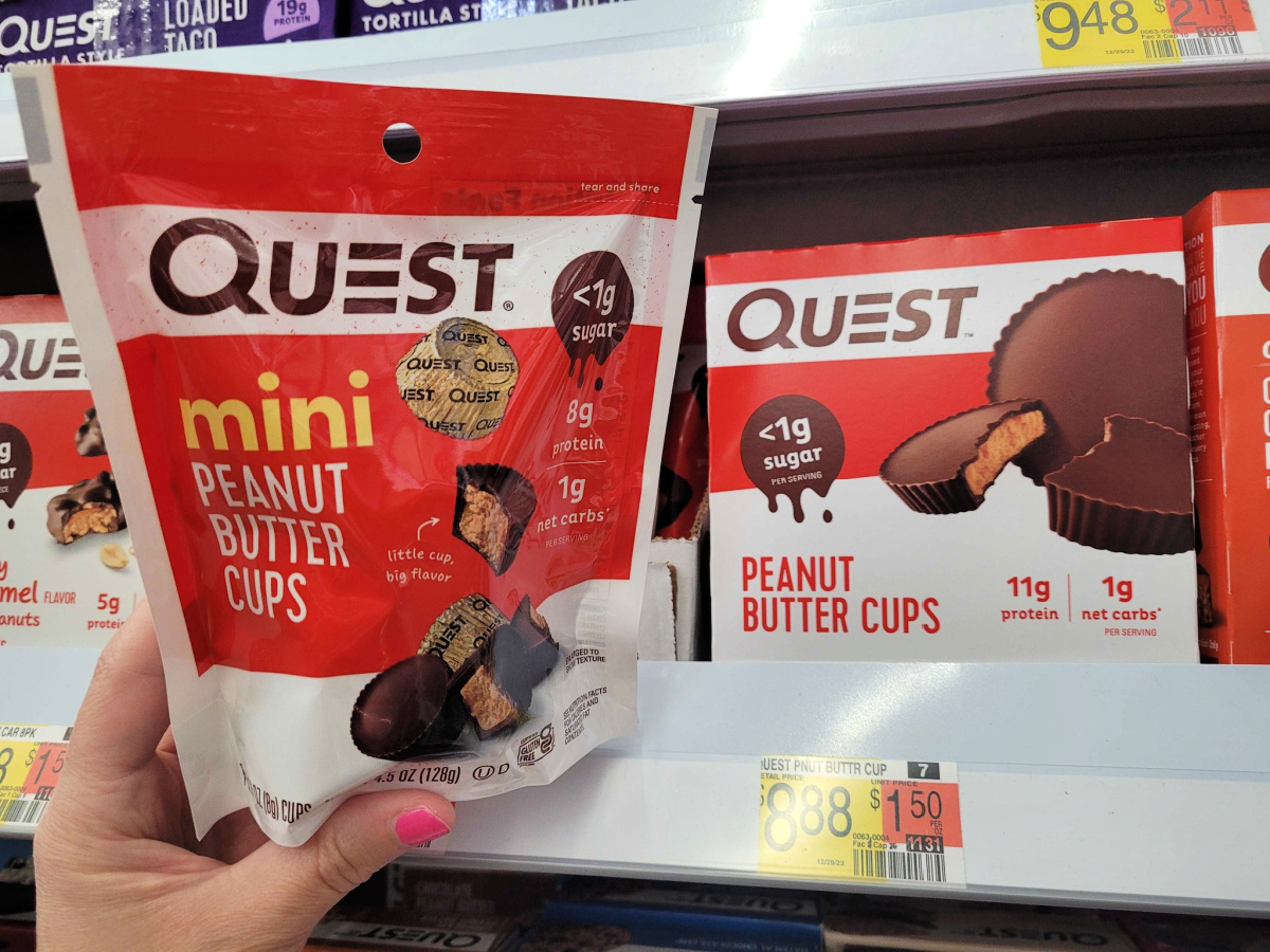 hand grabbing Quest mini Peanut Butter Cups, keto snacks at Walmart